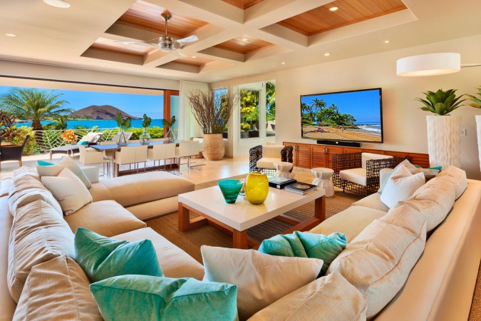 A luxurious living room with plush couches and a state-of-the-art TV.