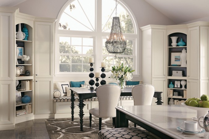 A white kitchen with a white table and chairs, featuring 8 Reasons to Love Window Seats.
