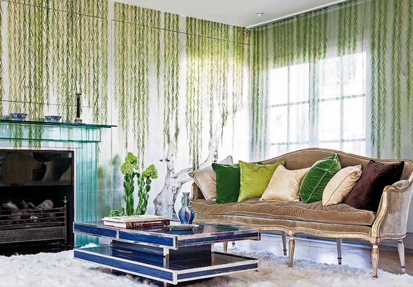 A living room with green wallpaper and a fireplace, shimmering and lustrous.