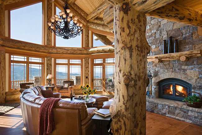 A luxurious living room in a log home with a fireplace.