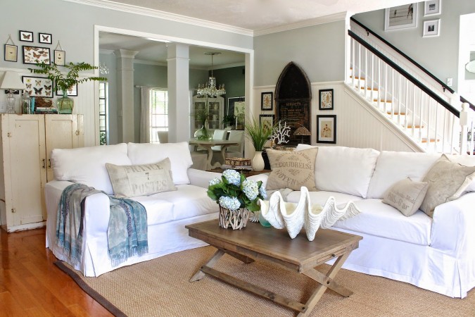 A living room with white couches and a coffee table, perfect for achieving a chic beach look in your home.