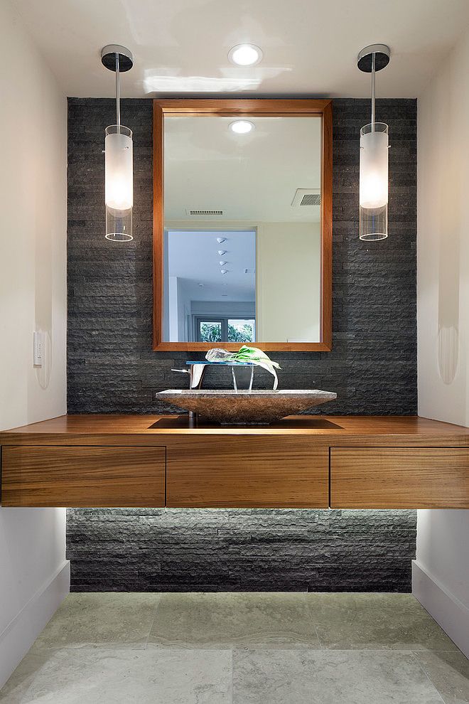 A modern bathroom with a unique wooden vanity and mirror.