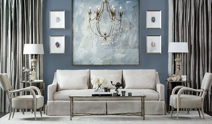 A living room with blue walls and a chandelier adding shimmer to your home.