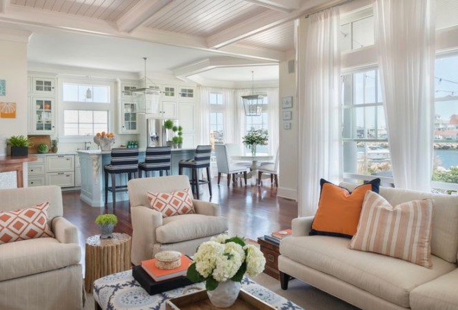 How to Get a Chic Beach Look in Your Home with white furniture and orange accents.