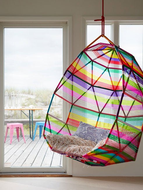 A vibrant hanging chair in a room.
