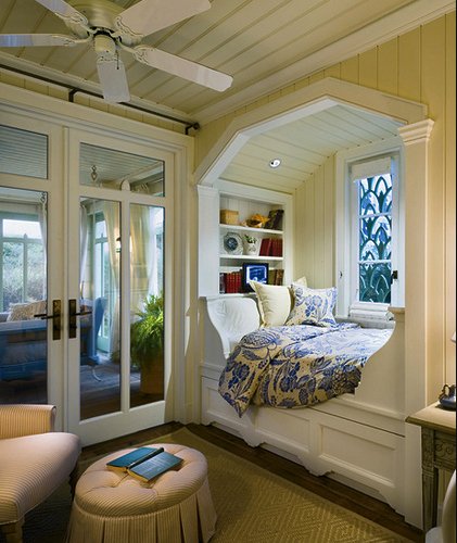 A bedroom with a bed and a window, featuring cozy nooks.