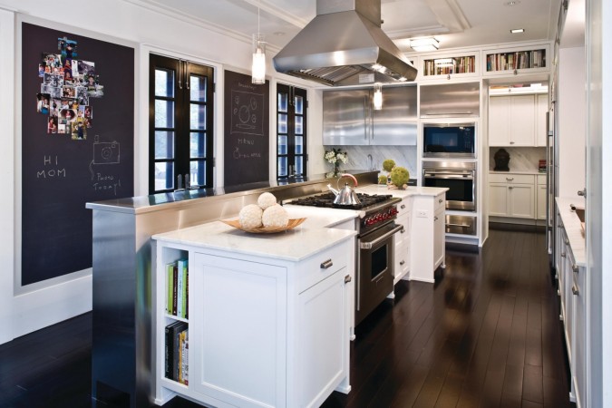 A white kitchen with a chalkboard wall, creating French charm.