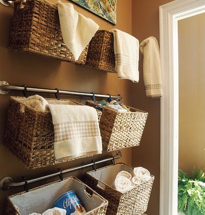 A bathroom with wicker baskets hanging on the wall offers one way to use baskets in your home.