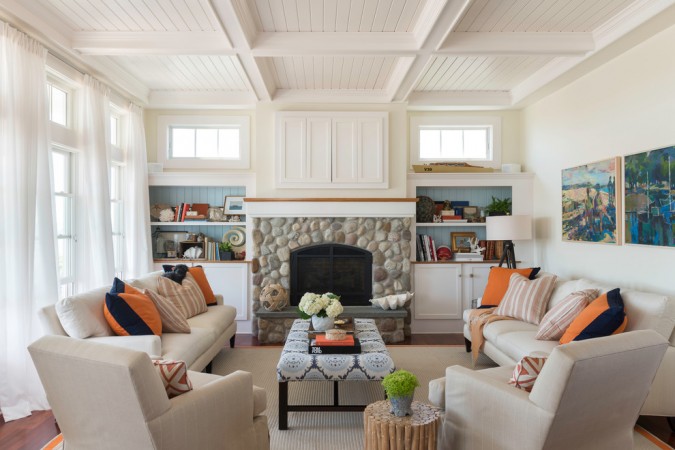 How to Get a Chic Beach Look in Your Home with white living room and orange accents.