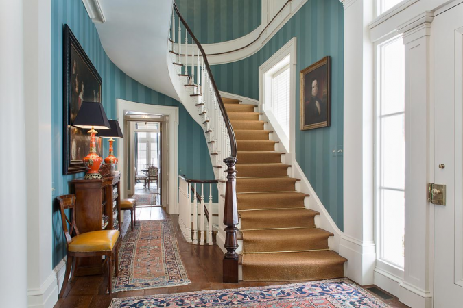 A luxurious stairway adorned with blue walls and a plush rug.