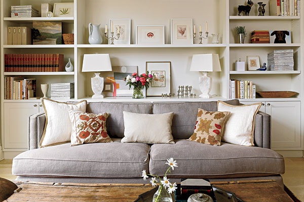 A living room with bookshelves and a gray couch.