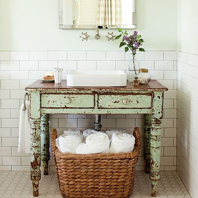 A vintage table is repurposed into a bathroom vanity 