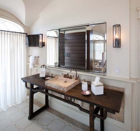 A sleek table is used as a bathroom vanity
