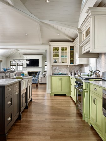Green, white and black cabinetry mix in this open kitchen 