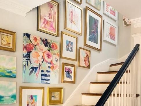 An inspirational stairway adorned with framed art.