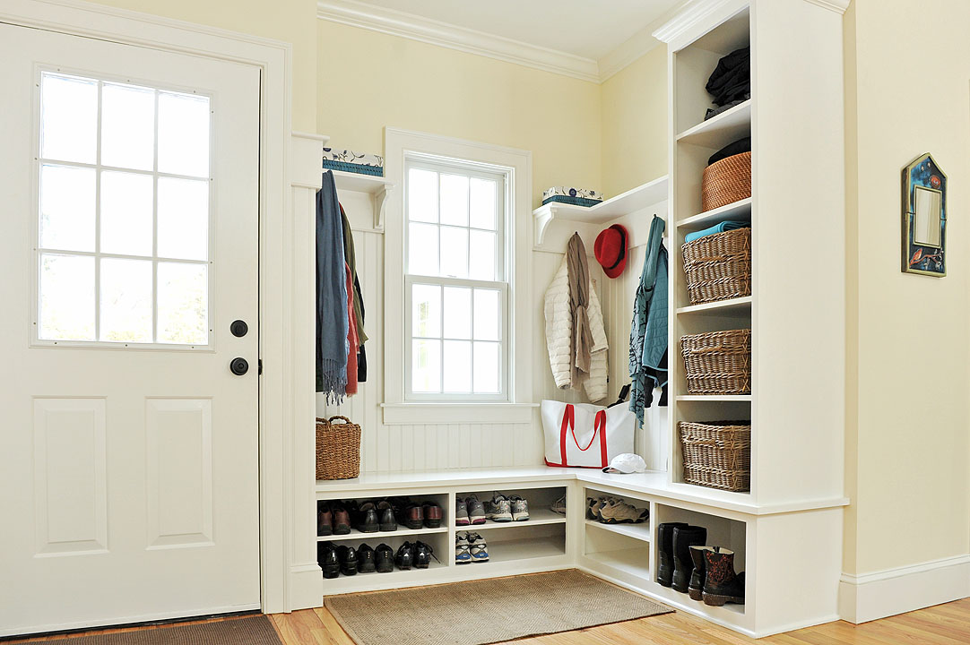 Two resale value boosting solutions for an unused mudroom space: shoe racks and coat racks.
