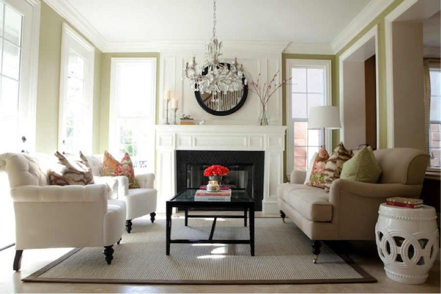A living room with white furniture and an affordable crystal chandelier.