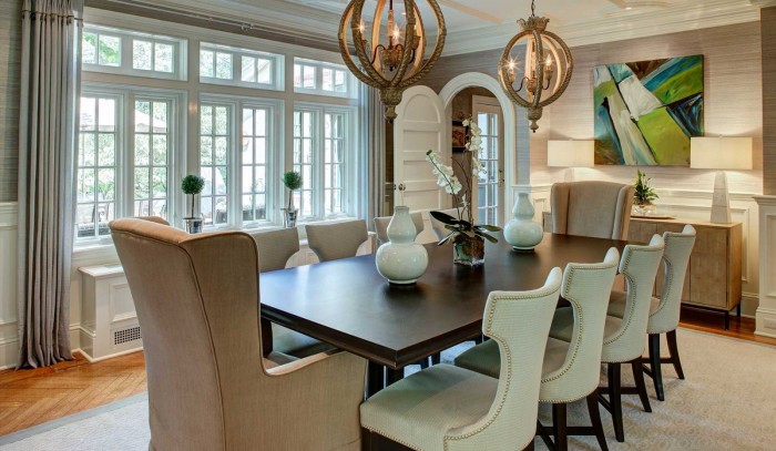 A dining room with a large table and chairs featuring light and fresh interiors.