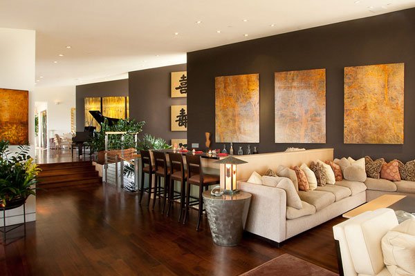 A Chinese-inspired living room with brown walls and wooden floors.