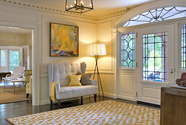 A settee and sunny accents give a welcoming vibe to this foyer