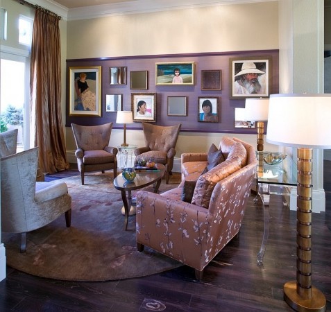 A fashionable living room with brown furniture and pictures on the wall.