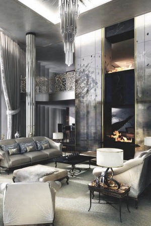 A chic living room with a chandelier and silver furniture.