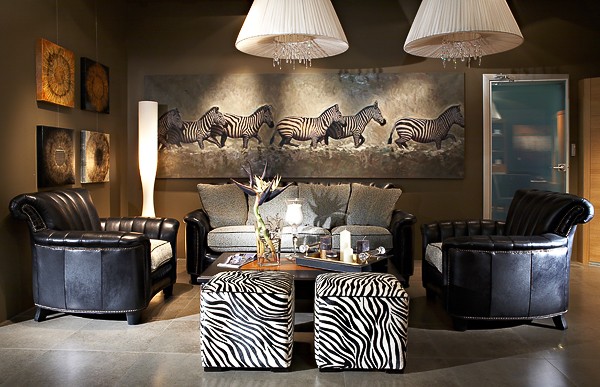 A living room with zebra print furniture and rugs, featuring interior design.