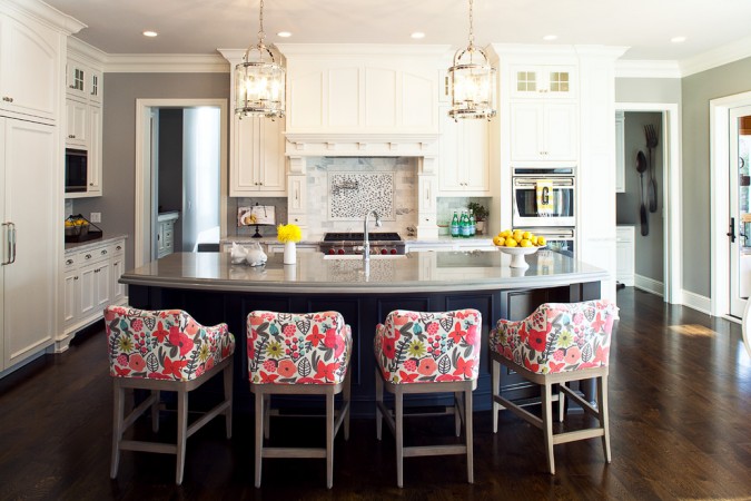 A kitchen with a center island and stylish stools.