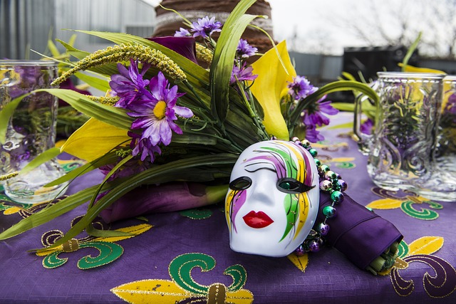 A Mardi Gras mask and flowers on a table, paying tribute to New Orleans.