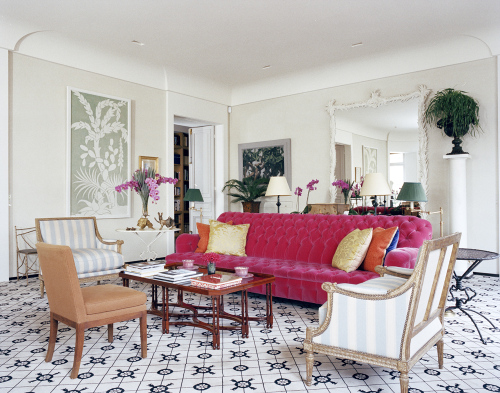 A pink couch in a living room with a designer focus on Jacques Grange.