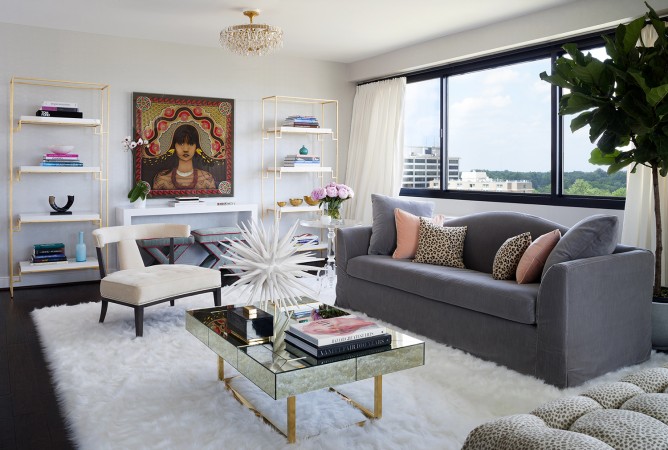 A fashionable living room with a chic couch and sleek coffee table.