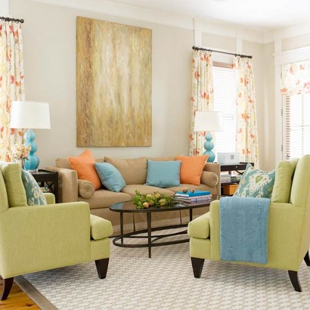 A living room with light and fresh orange, green, and blue accents for spring inspiration.