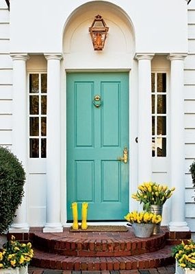 A house with a turquoise front door.