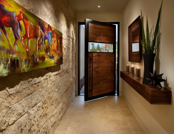 A wooden door and a painting create a stunning foyer to wow visitors.
