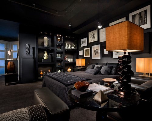 A bedroom with dark walls and a bed.