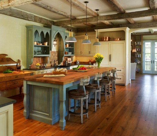 Industrial style bar stools offer a great contrast to this rustic kitchen 