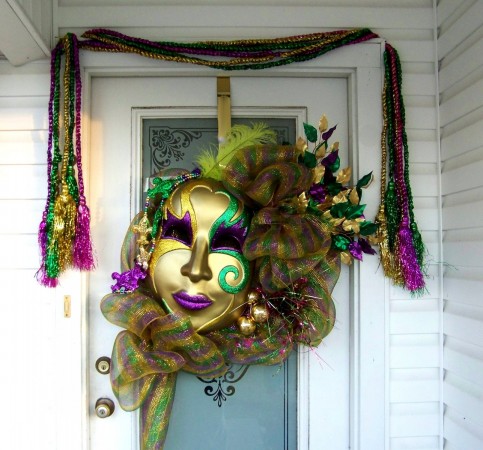 A Mardi Gras mask hanging on a door as a tribute to New Orleans.
