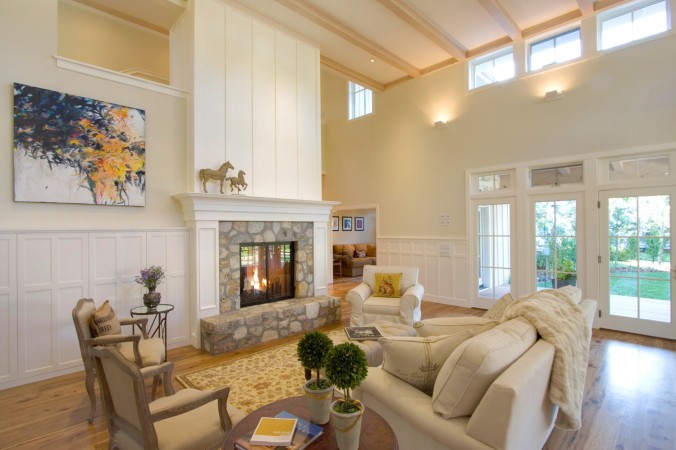 A living room with white walls and a fireplace, perfect for light and fresh interiors.