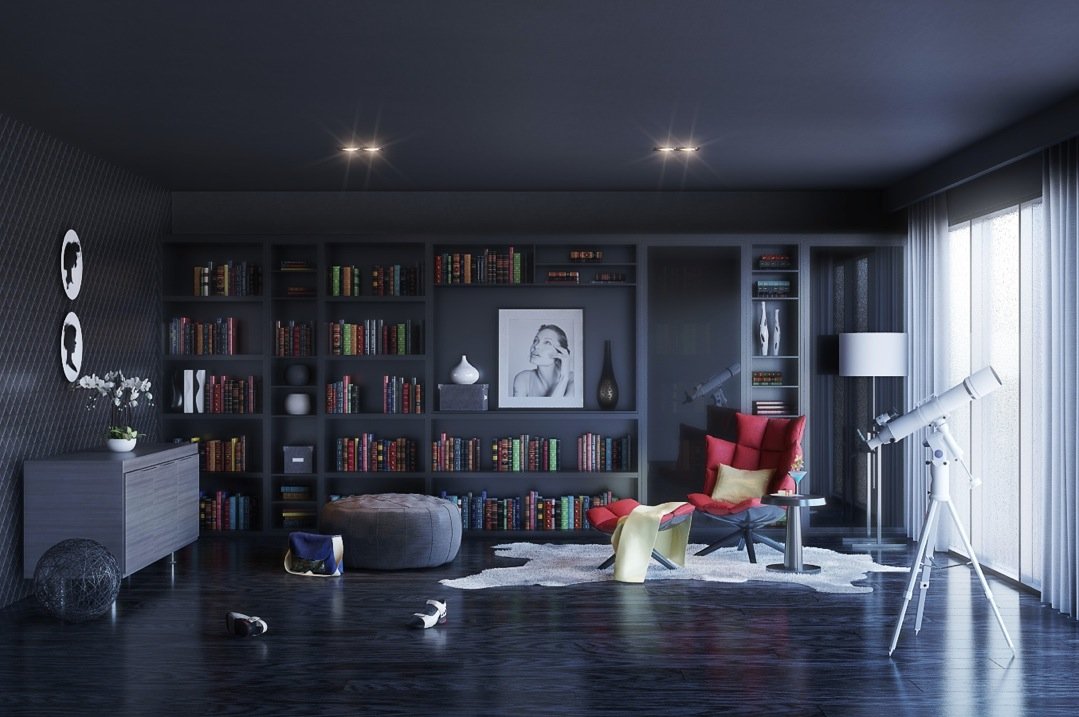 A dark living room with bookshelves and a red chair.