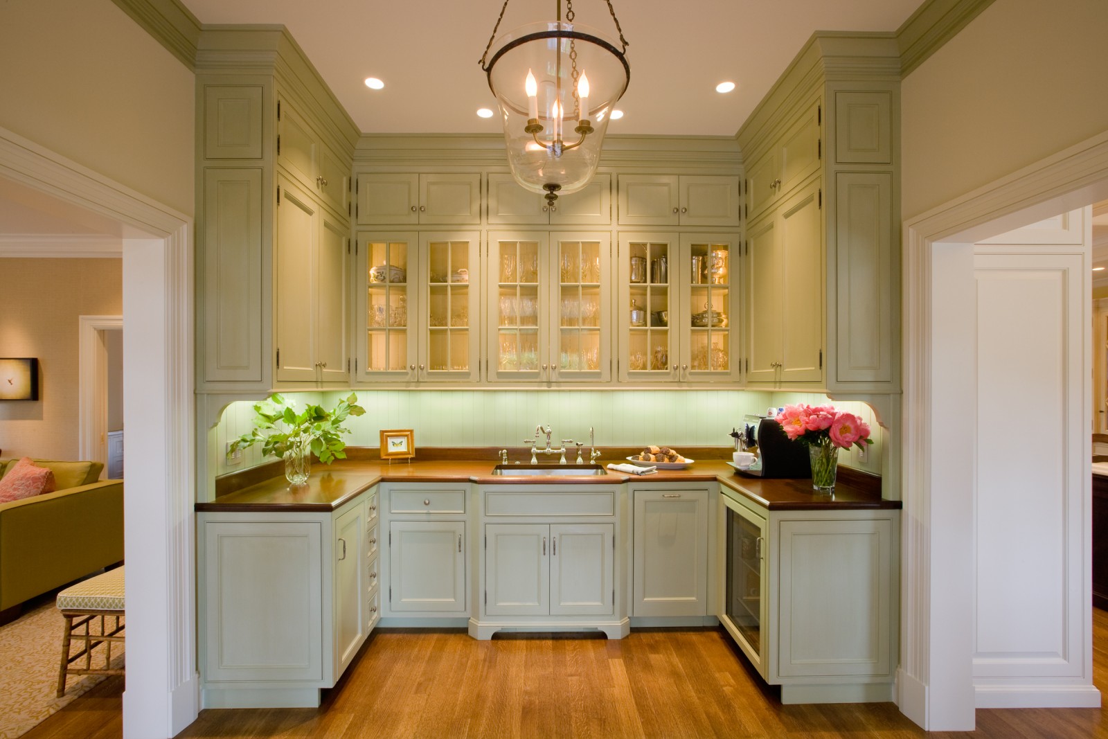 A kitchen with green cabinets offering two resale value boosting solutions for unused spaces.