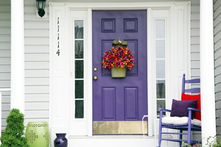 A purple front door with flower pot.