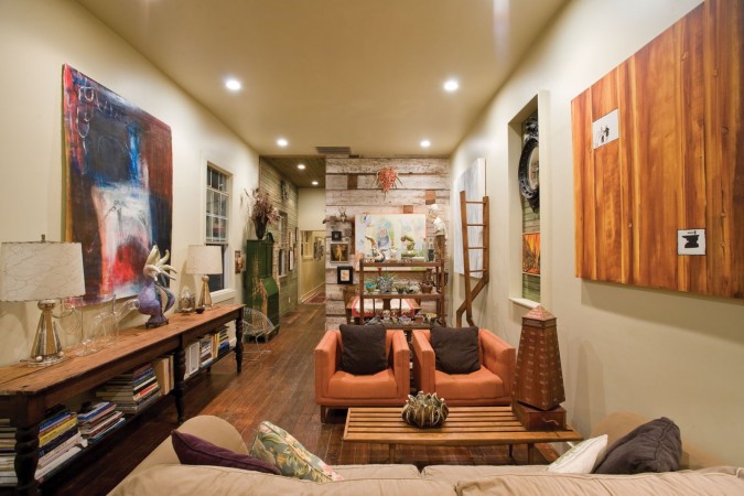 A living room with couches and a coffee table, featuring a tribute to New Orleans on Mardi Gras.
