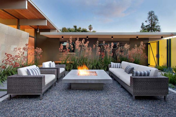 A modern backyard with a fire pit that heats up your landscape.
