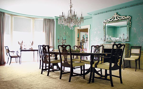 Affordable Chandelier in a dining room with green walls.
