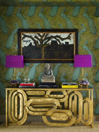A golden console adorned with vibrant purple lamps pays tribute to New Orleans during Mardi Gras.