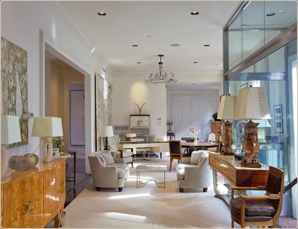 A living room with glass walls and furniture, featuring designer focus on Jacques Grange.