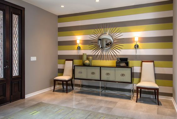 A striped accent wall enhances this foyer