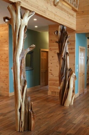 A room with a wooden floor and a tree trunk as furniture.