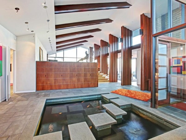 A modern home with a tranquil water feature in the entryway.