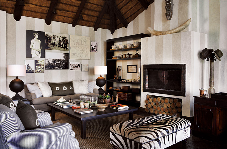 A living room with zebra print furniture and a fireplace, showcasing interior design.